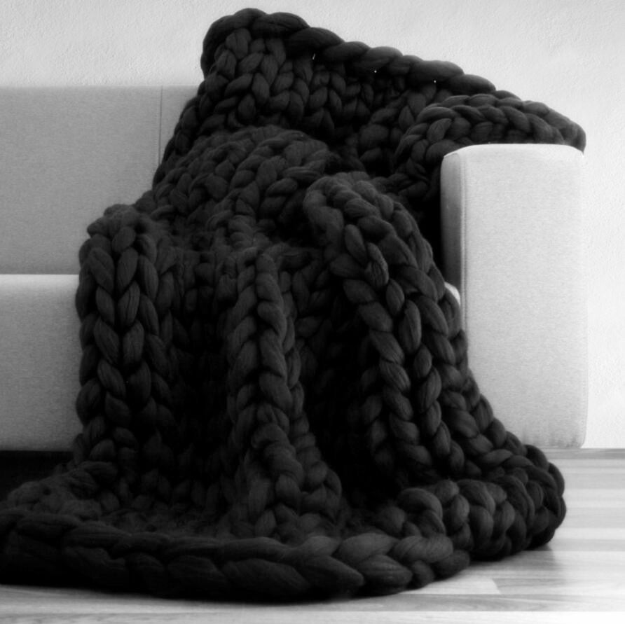 black knotte blanket in a grey sofa