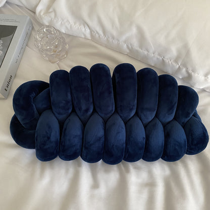 dark blue knotte caterpillar in a white bed