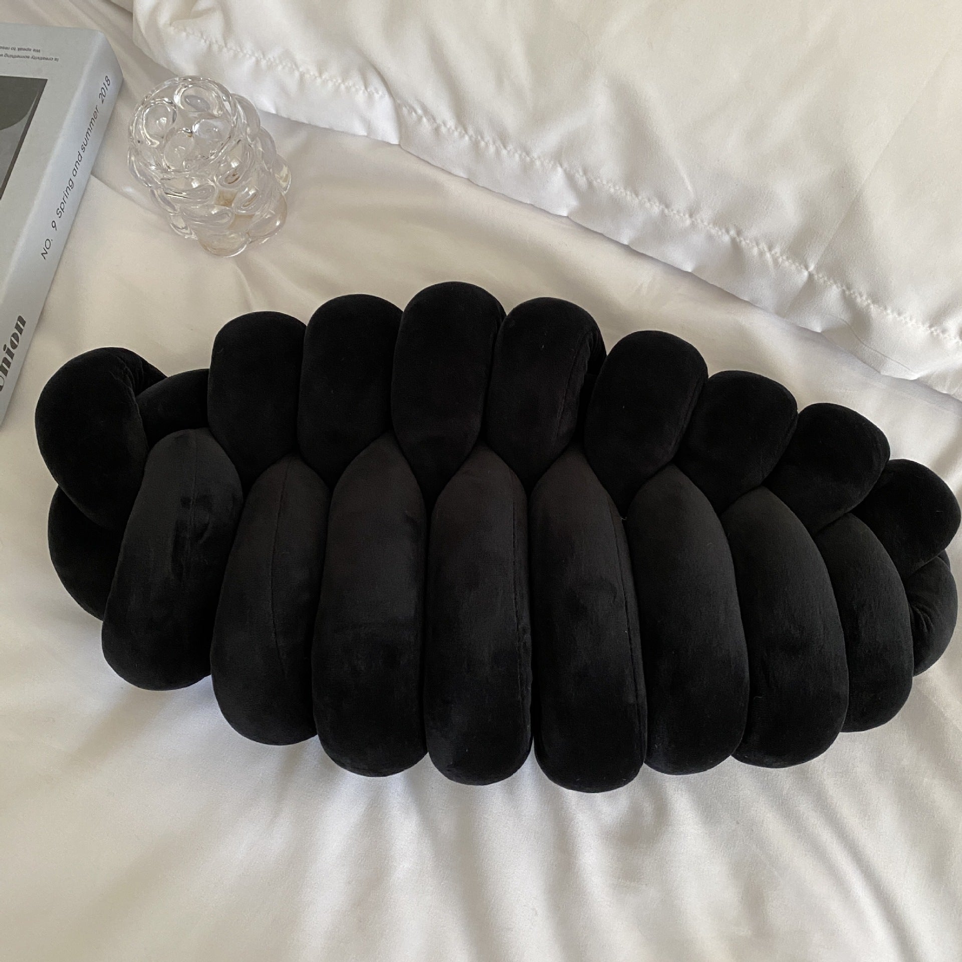 black knotte caterpillar in a white bed