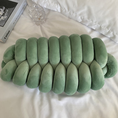 green knotte caterpillar in a white bed