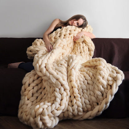 beige knotte blanket in a brown sofa