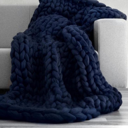 blue knotte blanket in a grey sofa