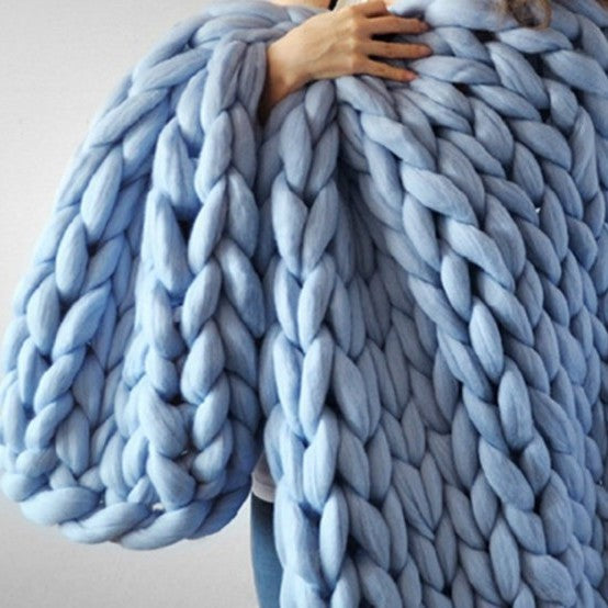 sky blue knotte blanket in a white background