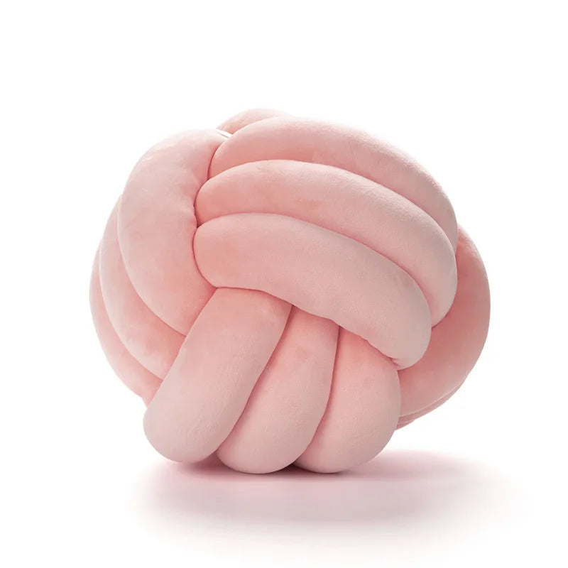 Pink knot pillow on a white background